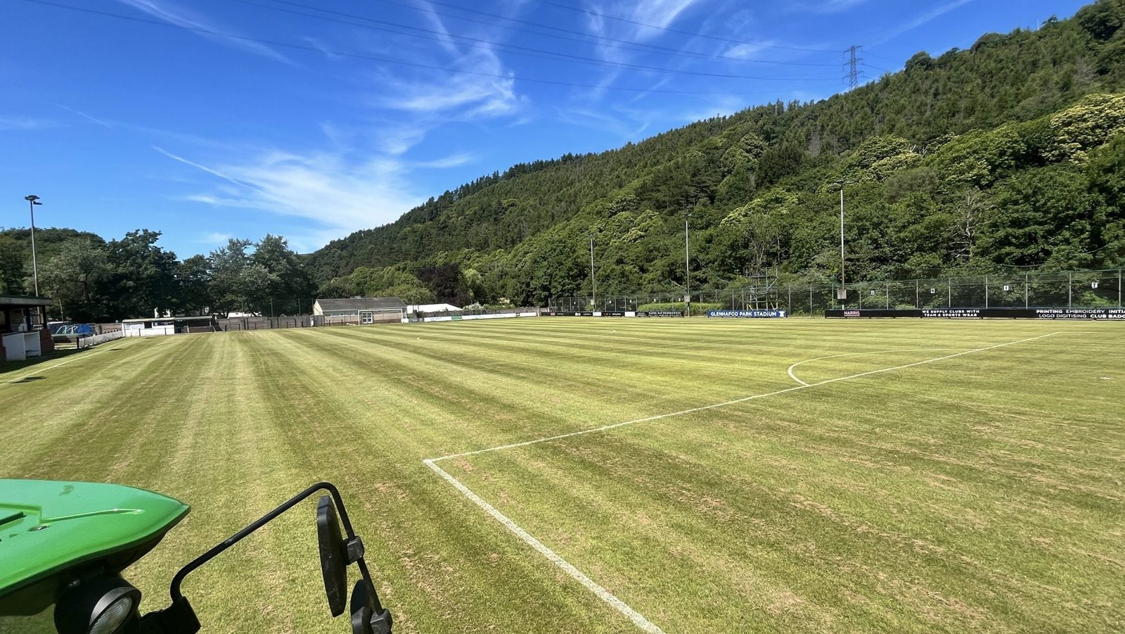 Freshly cut and striped football pitch at Goytre FC, Glenhafod Park Stadium, viewed from the tractor cab